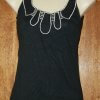 Black top with white stitching and cutouts
